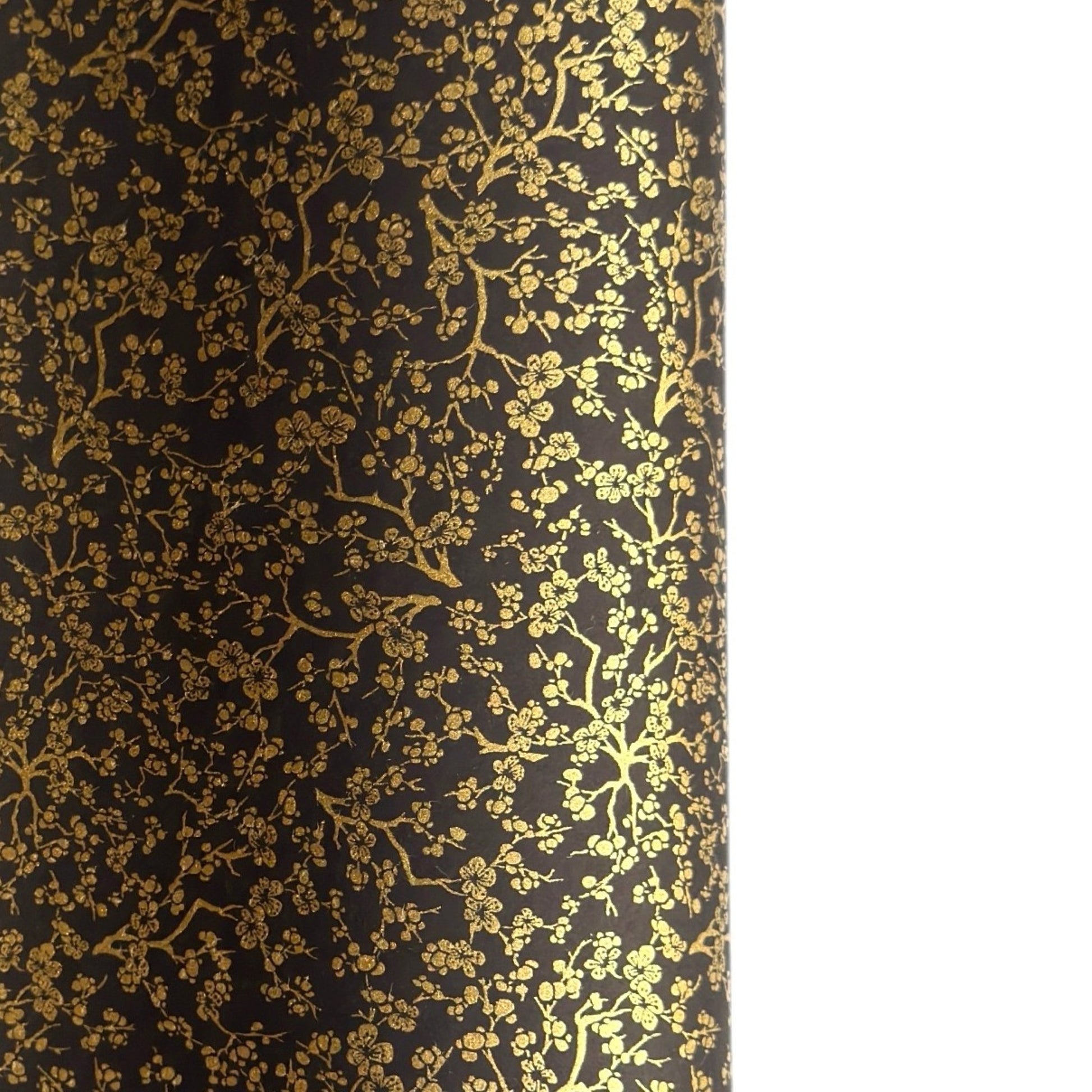 a sheet of Japanese chiyogami yuzen paper with a micro botanical pattern in gold on black