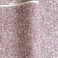 a sheet of Japanese silkscreen printed chiyogami yuzen paper with a micro floral pattern in aubergine, white and black