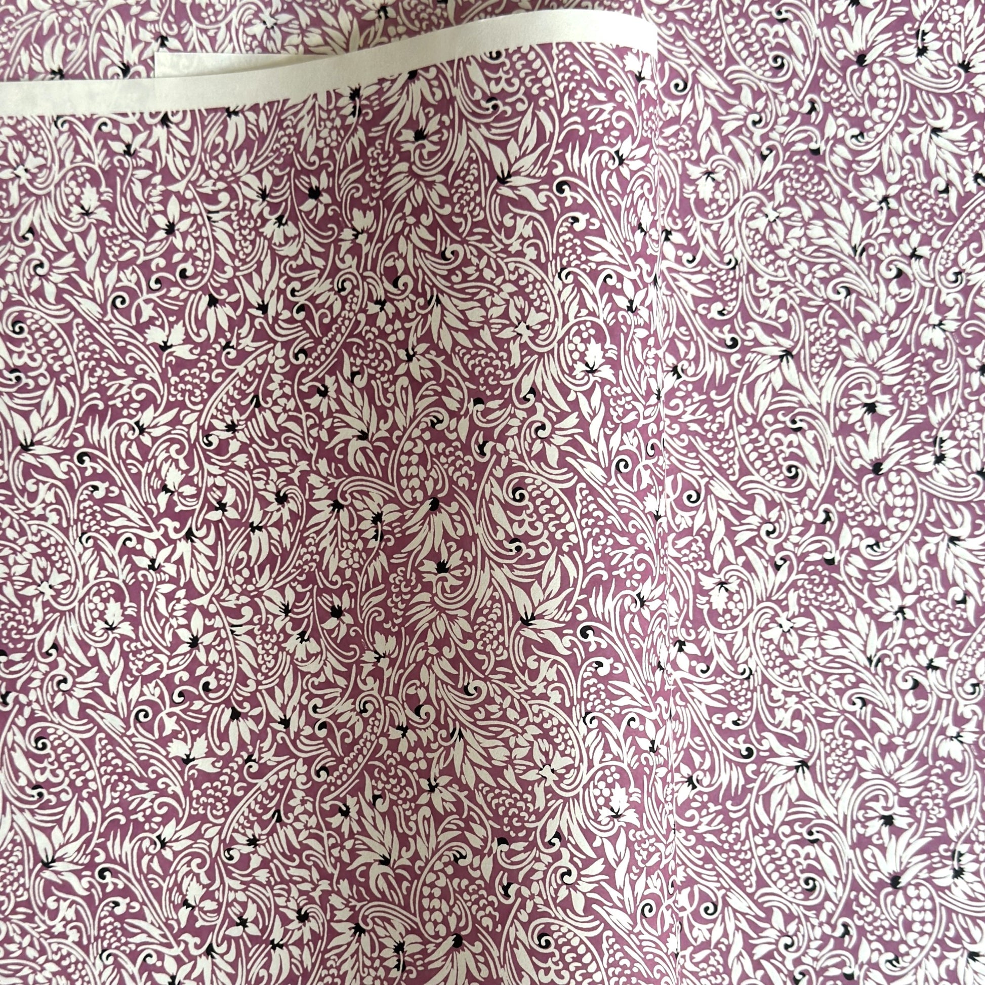 a sheet of Japanese silkscreen printed chiyogami yuzen paper with a micro floral pattern in aubergine, white and black