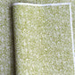 japanese silk-screen handmade paper showing green and white botanical repeat pattern with gold highlights