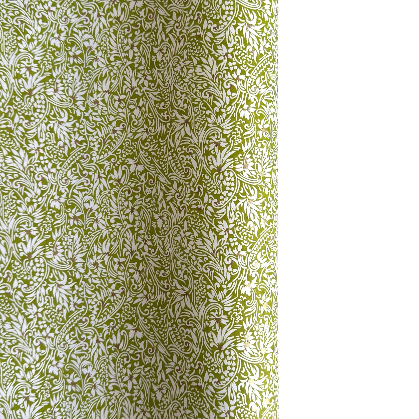 japanese silk-screen handmade paper showing green and white botanical repeat pattern with gold highlights