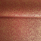 a sheet of Japanese chiyogami yuzen paper with a ditsy gold floral design on a deep red