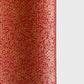 a sheet of Japanese chiyogami yuzen paper with a ditsy gold floral design on a deep red