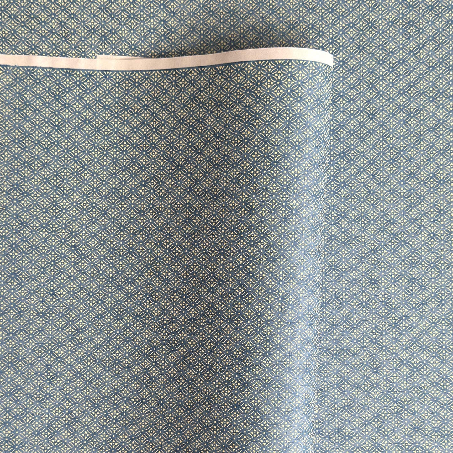 Japanese silkscreen chiyogami paper with a two-tone sky blue geometric pattern on creamy white