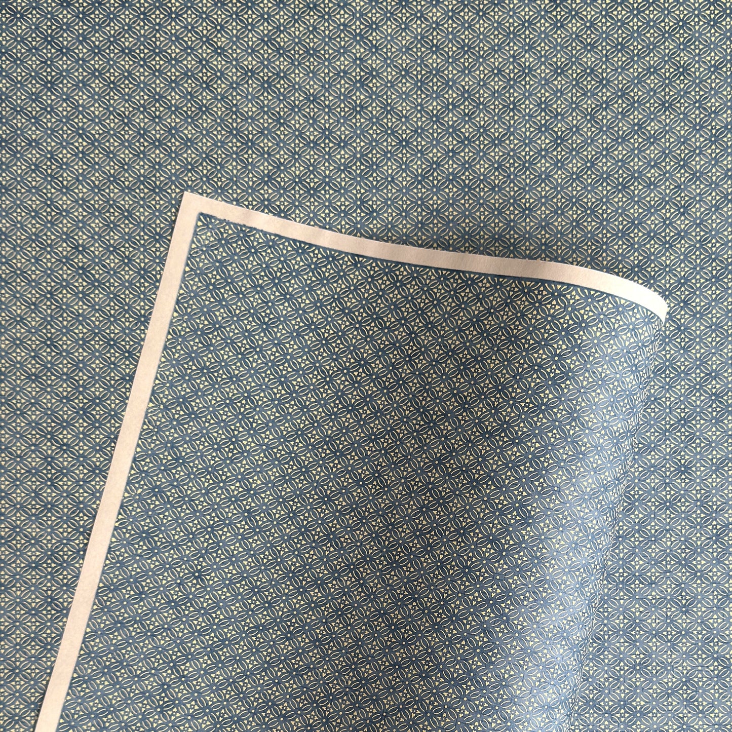 Japanese silkscreen chiyogami paper with a two-tone sky blue geometric pattern on creamy white