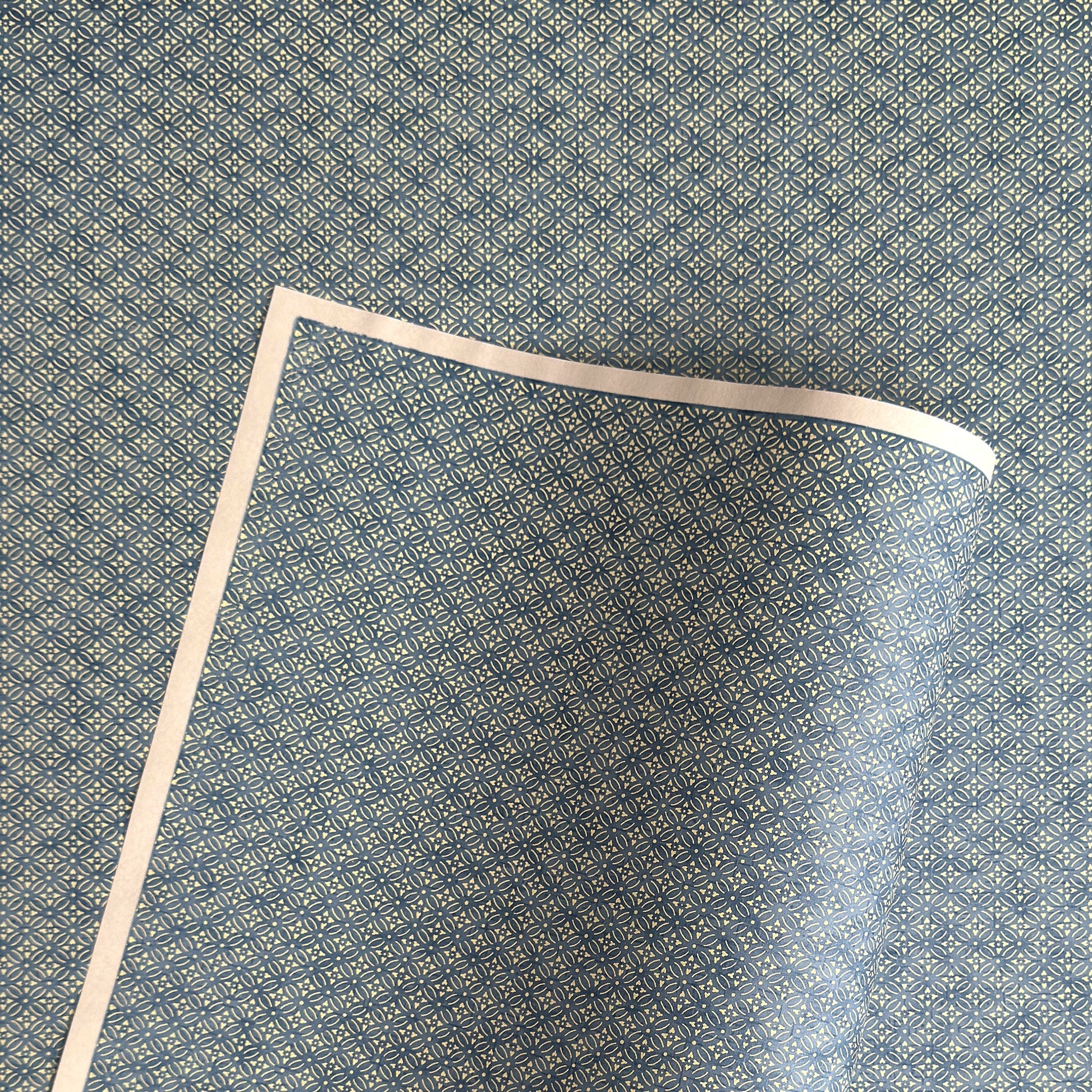 Japanese silkscreen chiyogami paper with a two-tone sky blue geometric pattern on creamy white