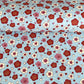 japanese silk-screen handmade paper showing red and pink plum flowers on a blue geometric backdrop