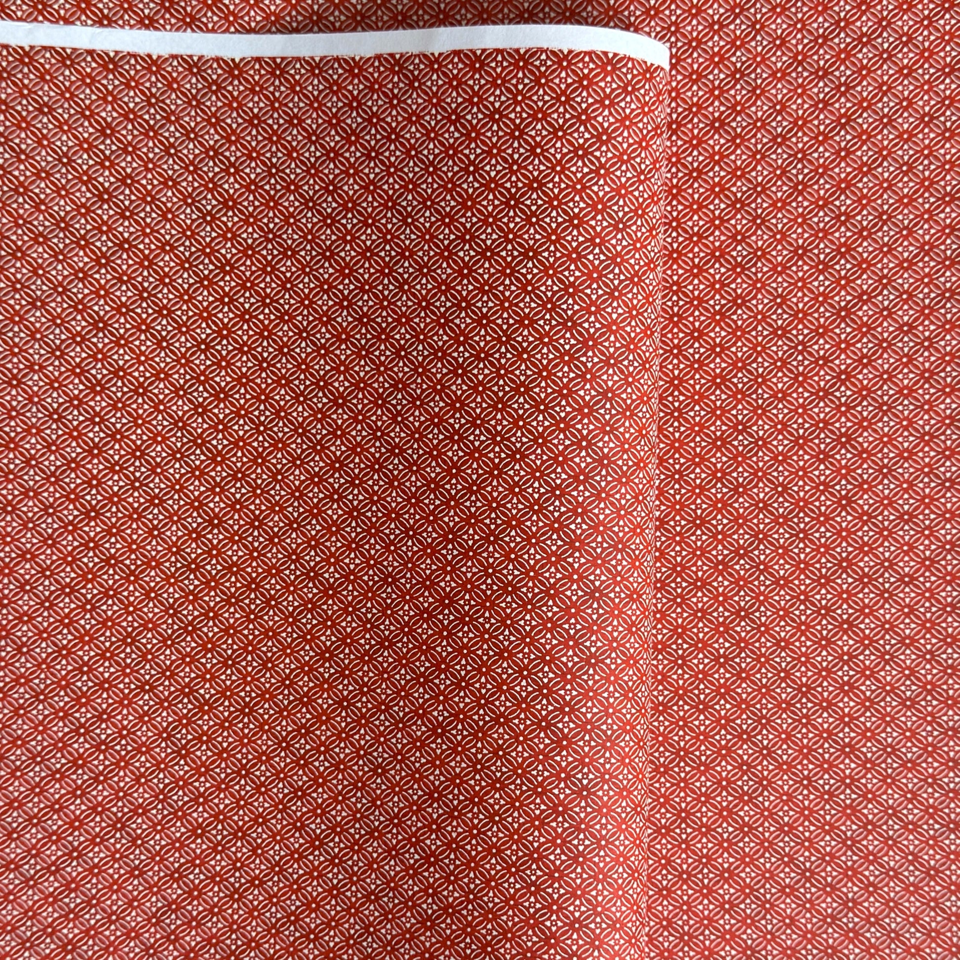 Japanese silkscreen chiyogami paper with a two-tone rich red geometric pattern on creamy white