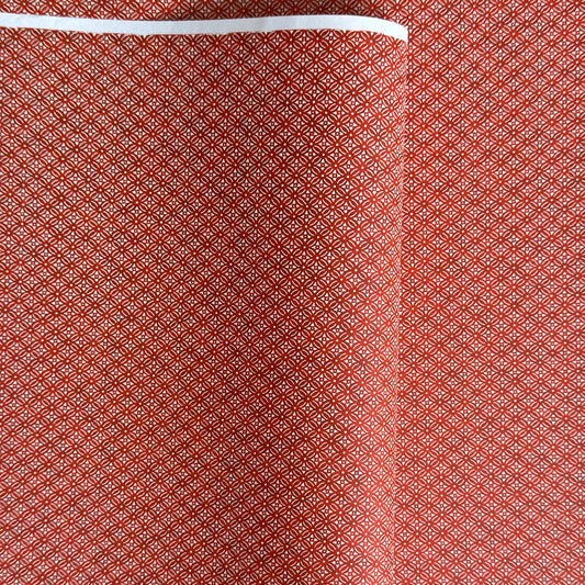 Japanese silkscreen chiyogami paper with a two-tone rich red geometric pattern on creamy white
