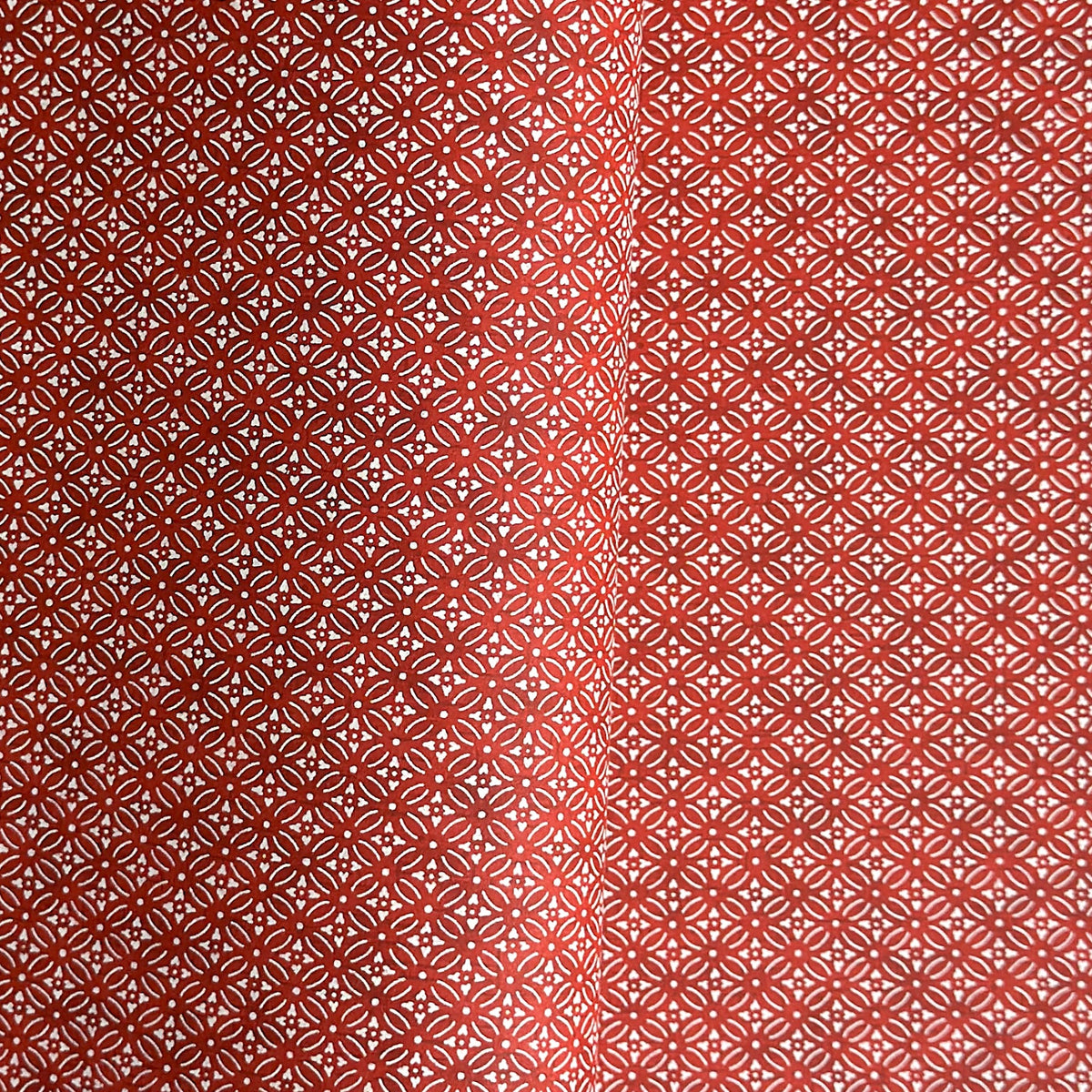 Japanese silkscreen chiyogami paper with a two-tone rich red geometric pattern on creamy white