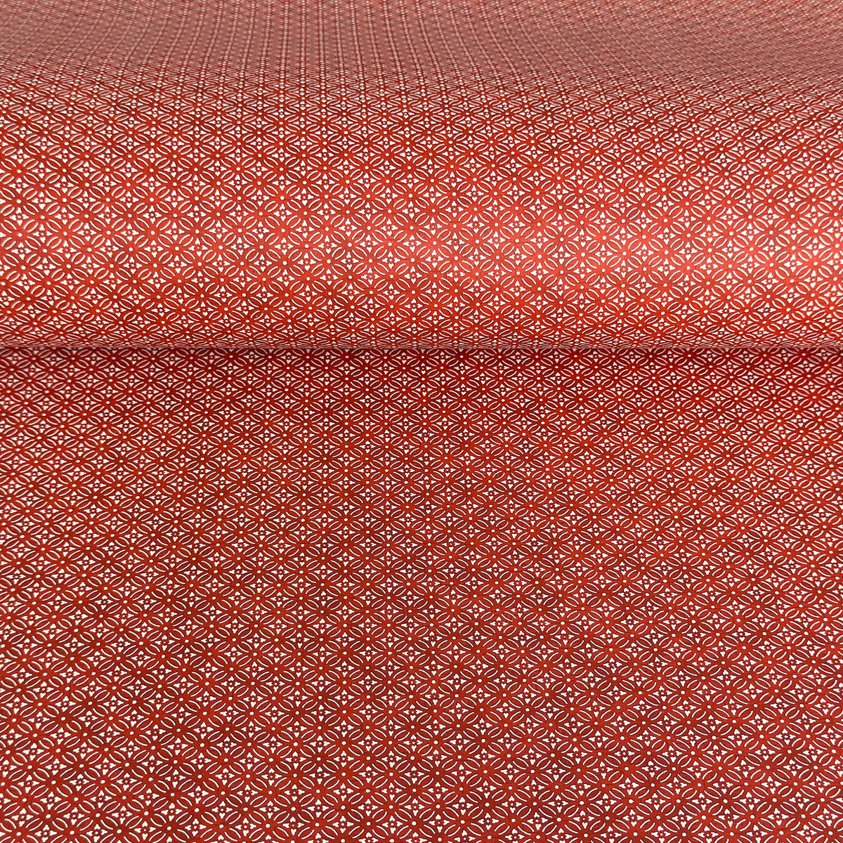 Japanese silkscreen chiyogami paper with a two-tone rich red geometric pattern on creamy white