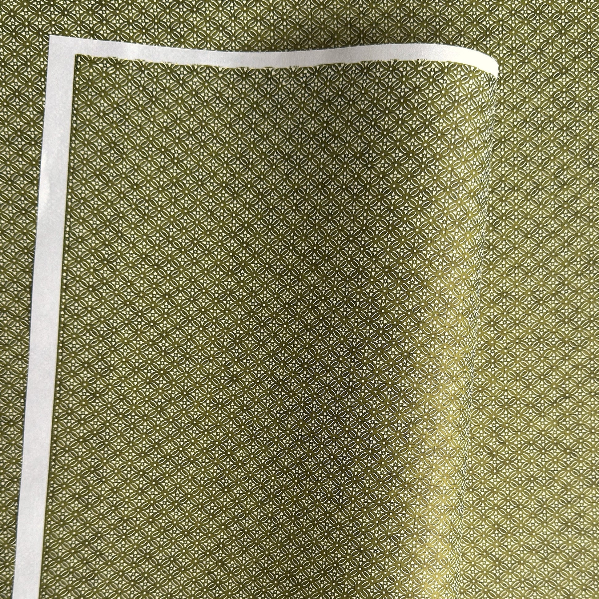 Japanese silkscreen chiyogami paper with a two-tone rich green geometric pattern on creamy white