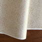 Japanese silkscreen chiyogami paper with an intricate floral pattern in gold on ivory white.