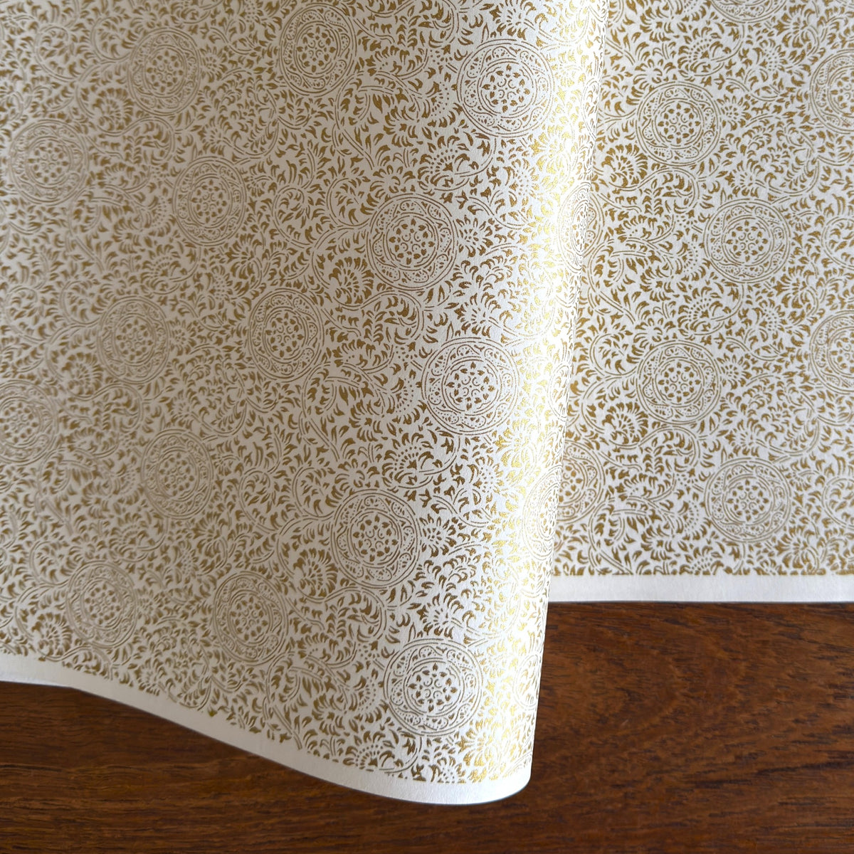Japanese silkscreen chiyogami paper with an intricate floral pattern in gold on ivory white.