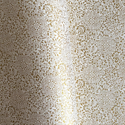 Japanese silkscreen chiyogami paper with an intricate floral pattern in gold on ivory white.