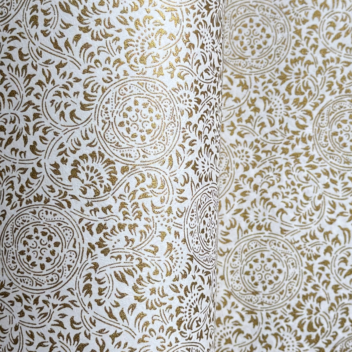 Japanese silkscreen chiyogami paper with an intricate floral pattern in gold on ivory white.