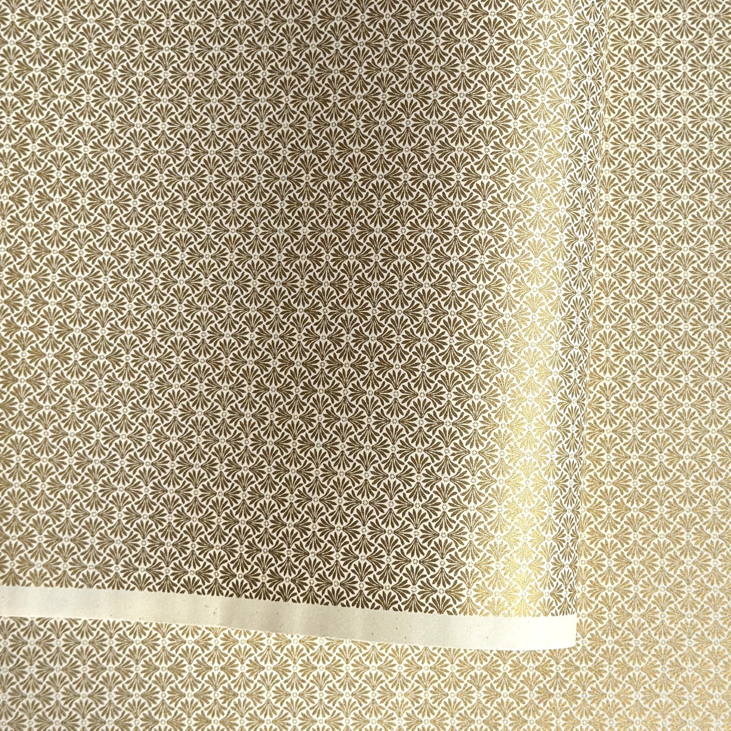 a sheet of Japanese silkscreen printed chiyogami yuzen paper with a micro gold geometric pattern on white backdrop. 