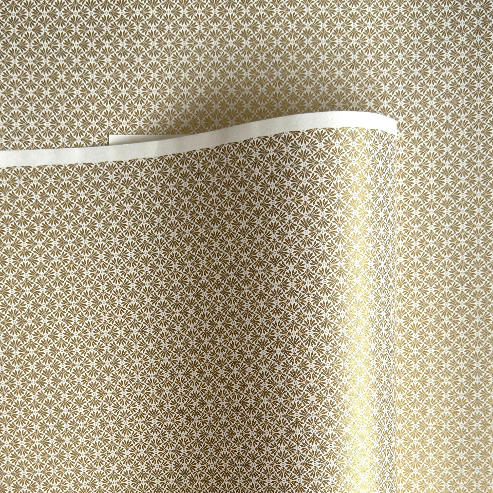 a sheet of Japanese silkscreen printed chiyogami yuzen paper with a micro gold geometric pattern on white backdrop. 