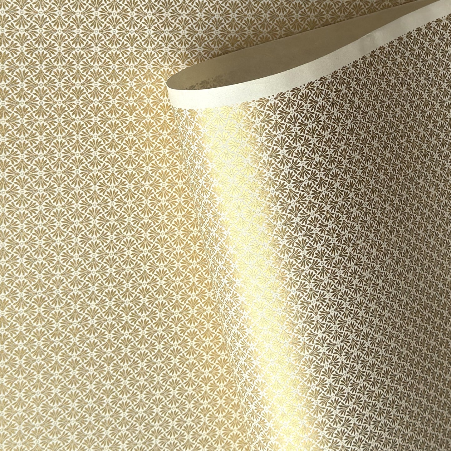a sheet of Japanese silkscreen printed chiyogami yuzen paper with a micro gold geometric pattern on white backdrop. 