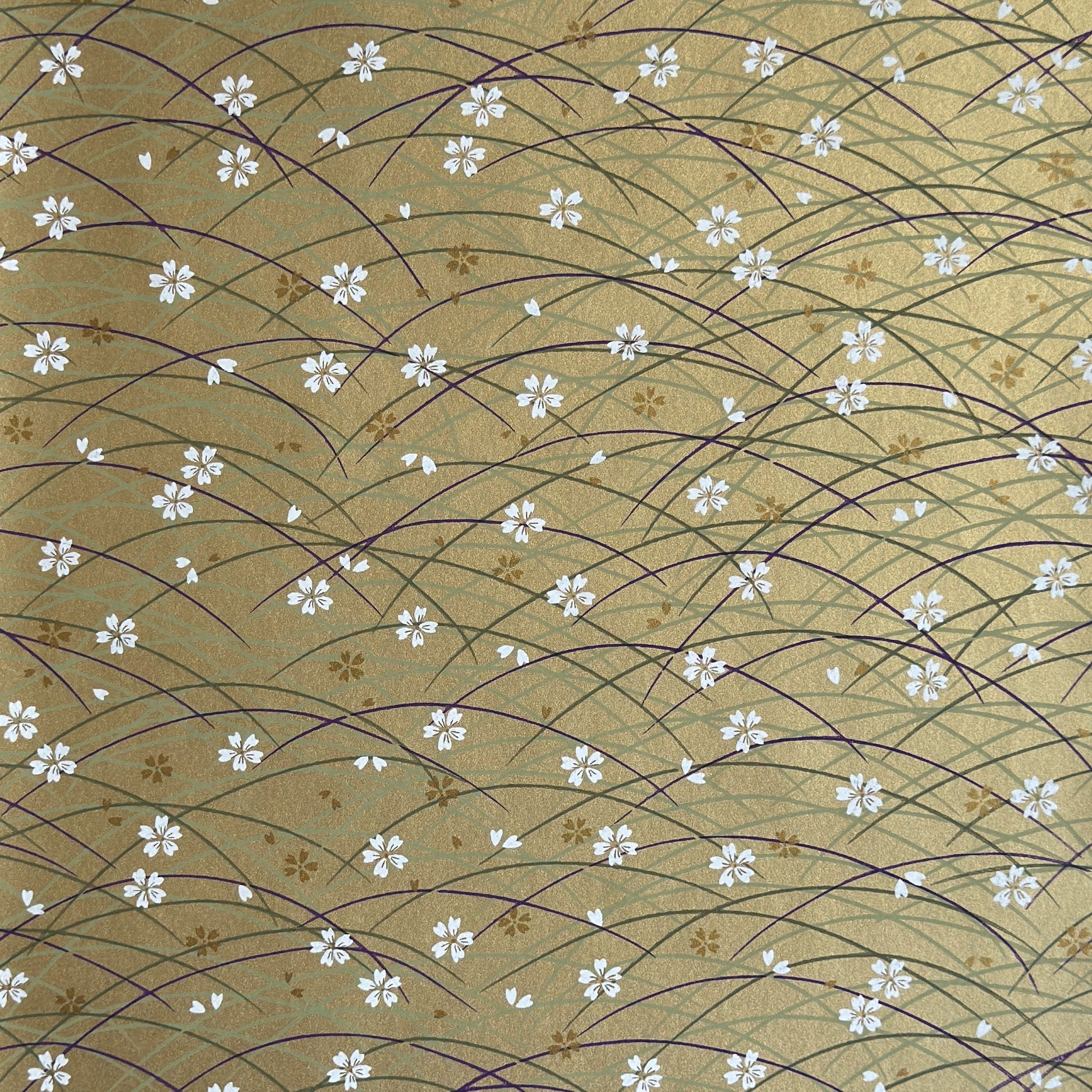 Japanese silkscreen chiyogami paper with a pattern of purple arches and white cherry blossom on antique gold backdrop