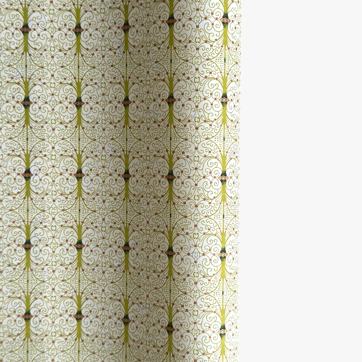 japanese silk-screen handmade paper showing green filigree pattern with gold accents