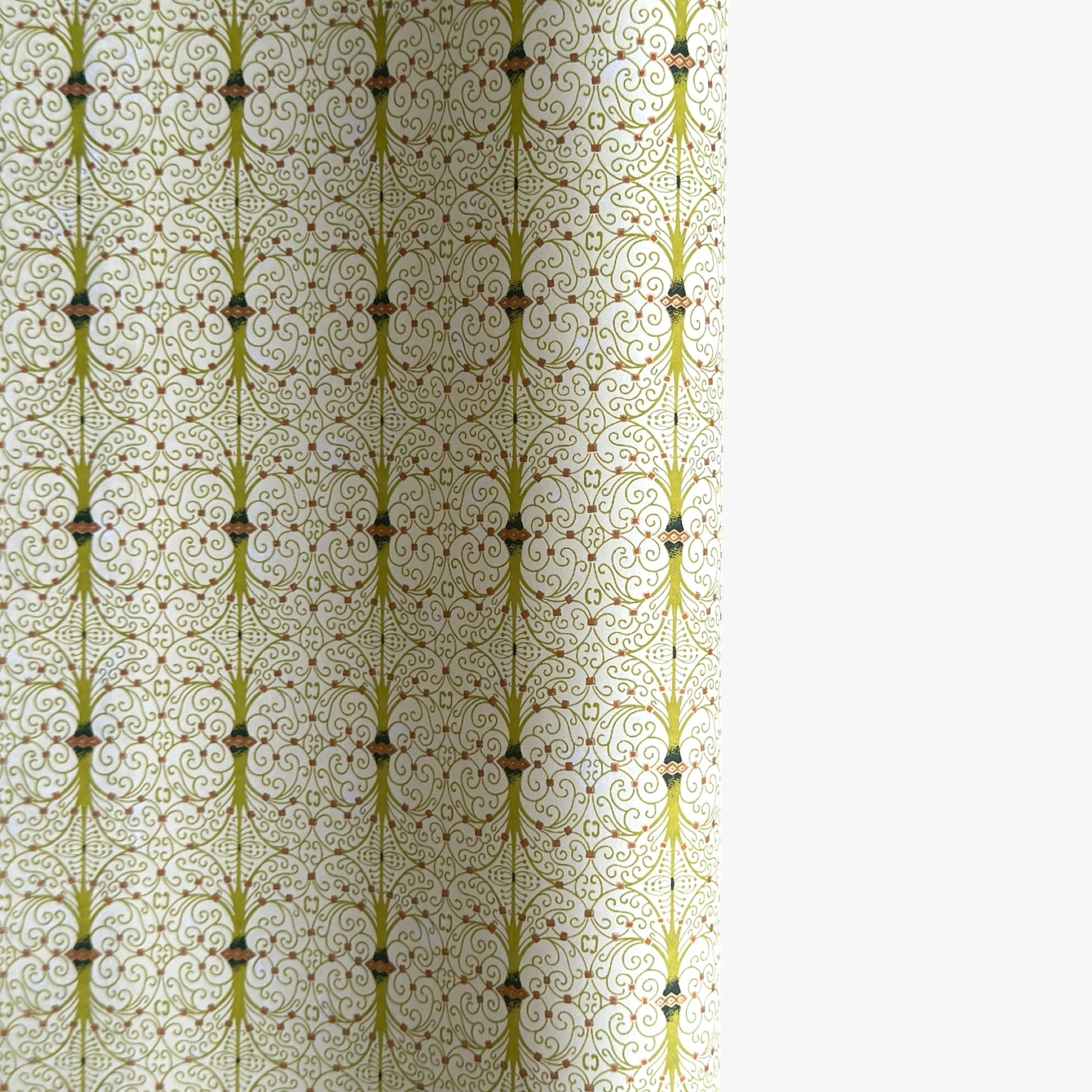 japanese silk-screen handmade paper showing green filigree pattern with gold accents