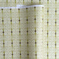 japanese silk-screen handmade paper showing green filigree pattern with gold accents