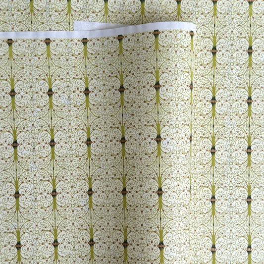 japanese silk-screen handmade paper showing green filigree pattern with gold accents