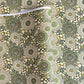 Japanese silkscreen chiyogami paper with a repeat pattern of stylised chrysanthemum flowers in tones of deep green on a buttermilk cream backdrop.