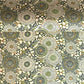 Japanese silkscreen chiyogami paper with a repeat pattern of stylised chrysanthemum flowers in tones of deep green on a buttermilk cream backdrop.