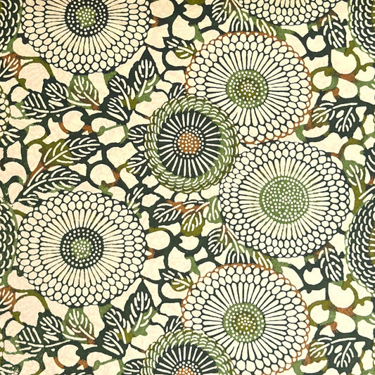 Japanese silkscreen chiyogami paper with a repeat pattern of stylised chrysanthemum flowers in tones of deep green on a buttermilk cream backdrop.