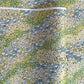 Japanese silkscreen chiyogami paper with a pattern of dark green rivers and grass green banks with an abundance of little flowers in white and yellow