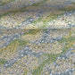 Japanese silkscreen chiyogami paper with a pattern of dark green rivers and grass green banks with an abundance of little flowers in white and yellow