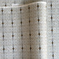 Japanese silkscreen chiyogami paper with a intricate filigree trellis design in grey with gold accent