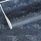 Japanese chiyogami paper.  Inky blue with a subtle pattern of a riverbank of flowers.  