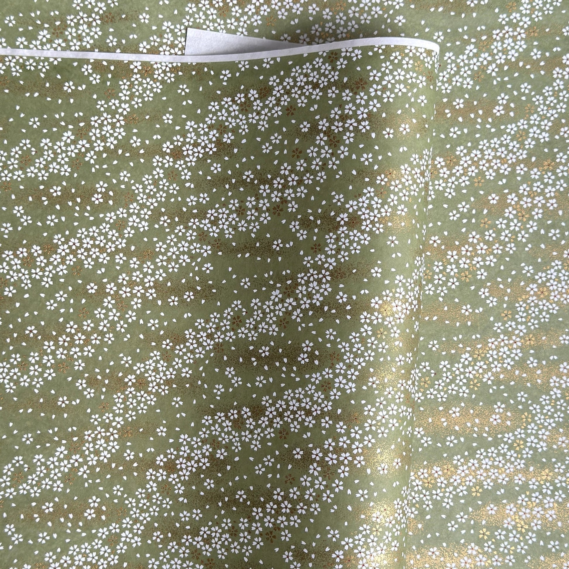 Waves of dainty white and gold flowers on a sage backdrop. Japanese chiyogami paper