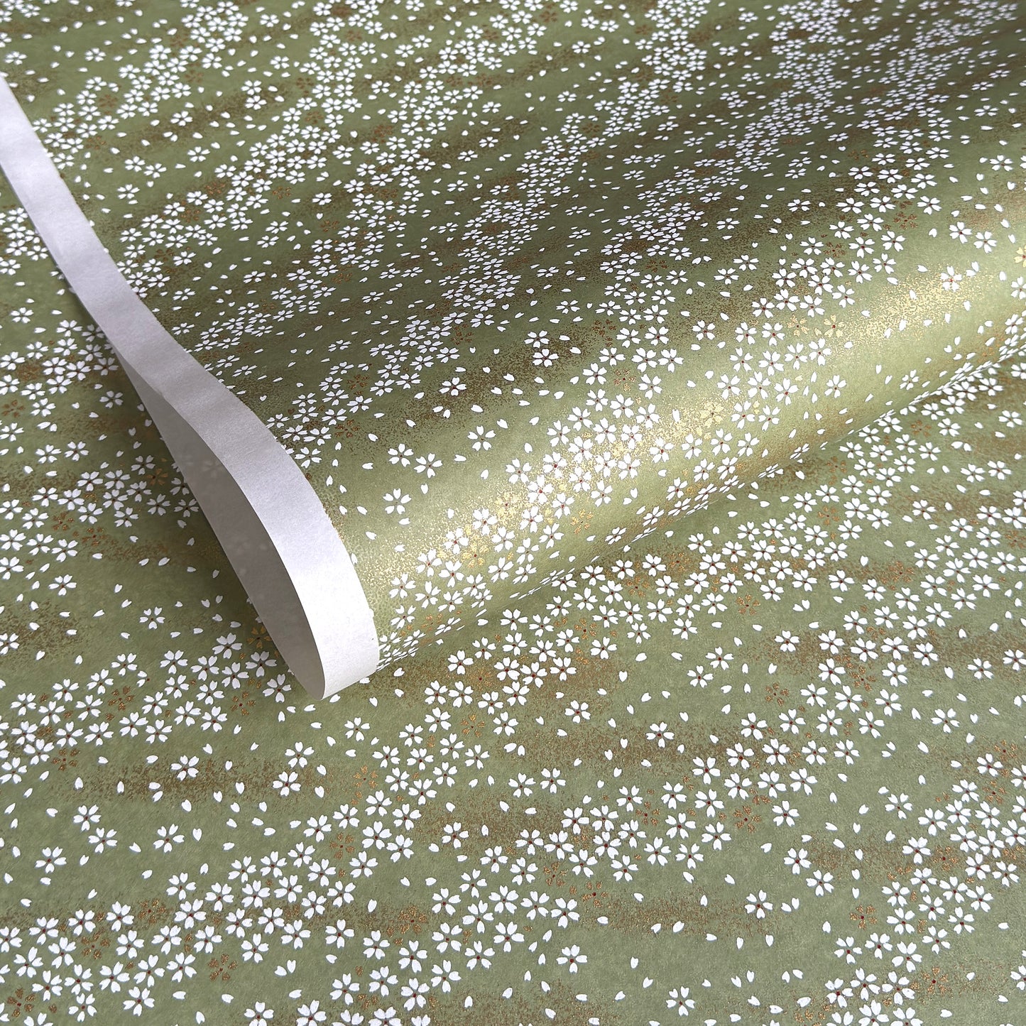 Waves of dainty white and gold flowers on a sage backdrop. Japanese chiyogami paper
