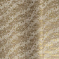a sheet of Japanese silkscreen printed chiyogami paper with waves of tiny white and gold flowers on a soft taupe background with a dusting of gold.