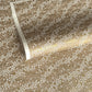 a sheet of Japanese silkscreen printed chiyogami paper with waves of tiny white and gold flowers on a soft taupe background with a dusting of gold.