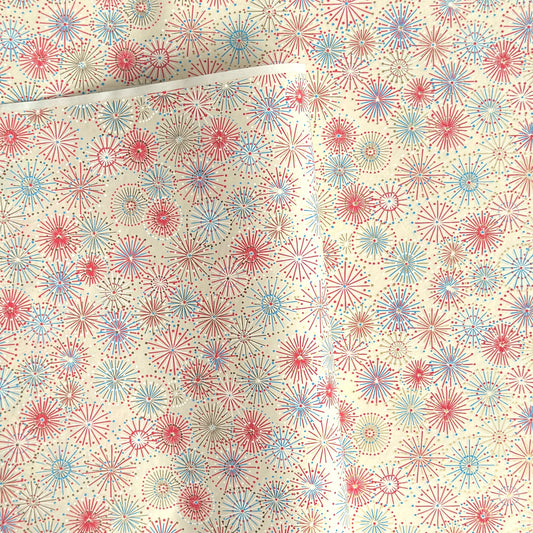 japanese chiyogami silkscreen printed paper with a pattern of fireworks in reds, pinks and lilacs on an ivory background.