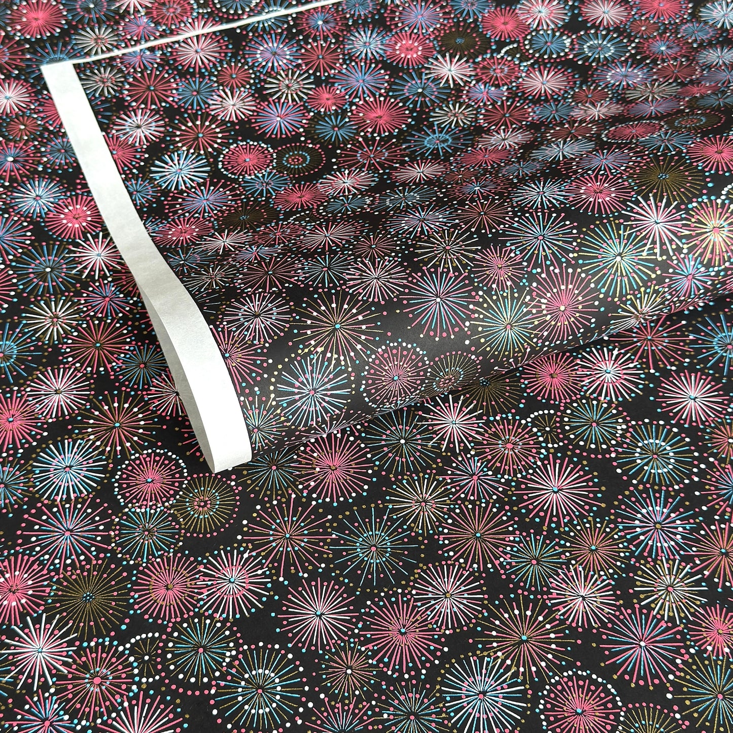 Colourful fireworks (hanabi) on a black background. Japanese chiyogami paper