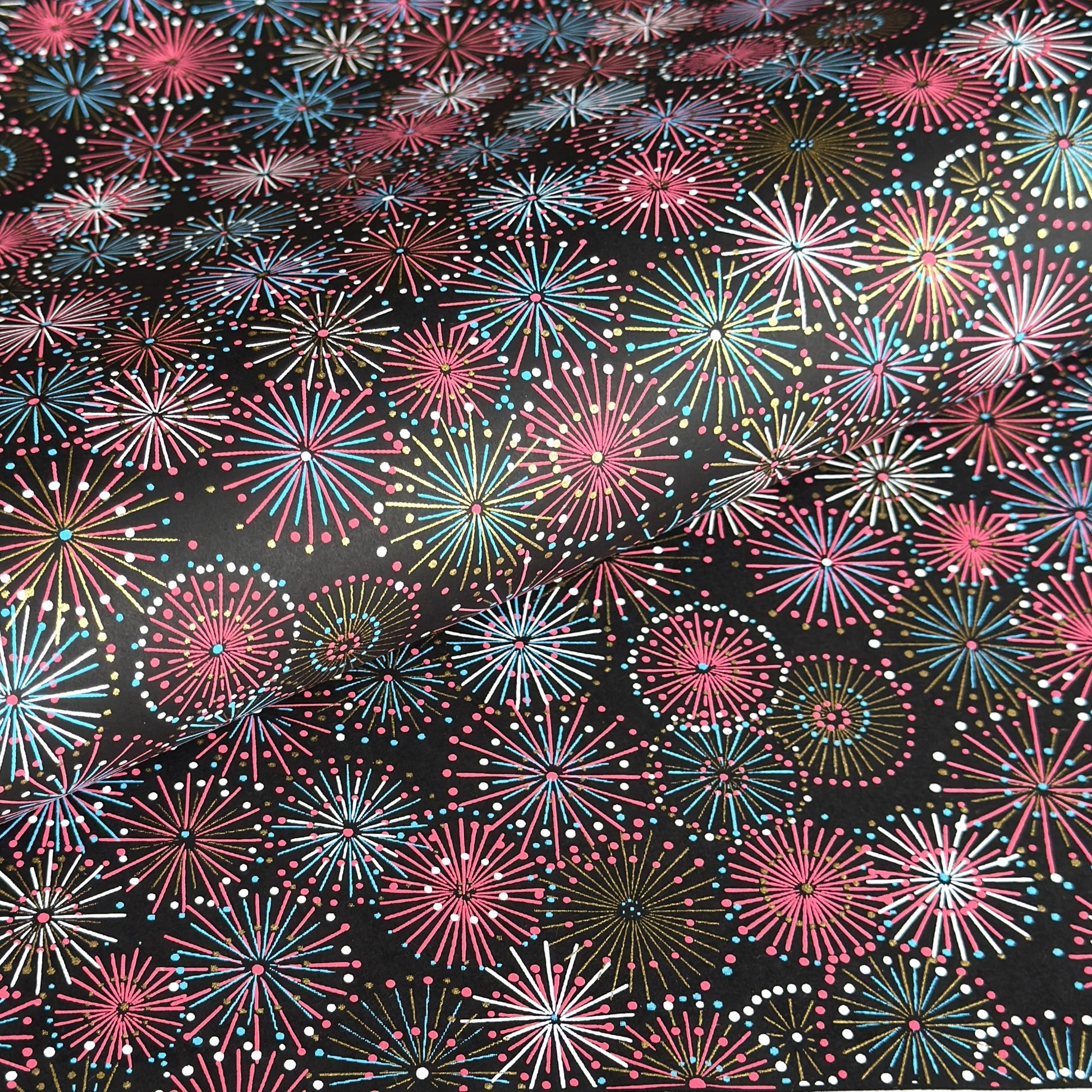 Colourful fireworks (hanabi) on a black background. Japanese chiyogami paper