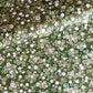 Japanese chiyogami paper with white and pale green blossom flowers on dark green backdrop.