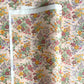 japanese silkscreen printed paper with a delicate floral bouquet design on blush pink background.