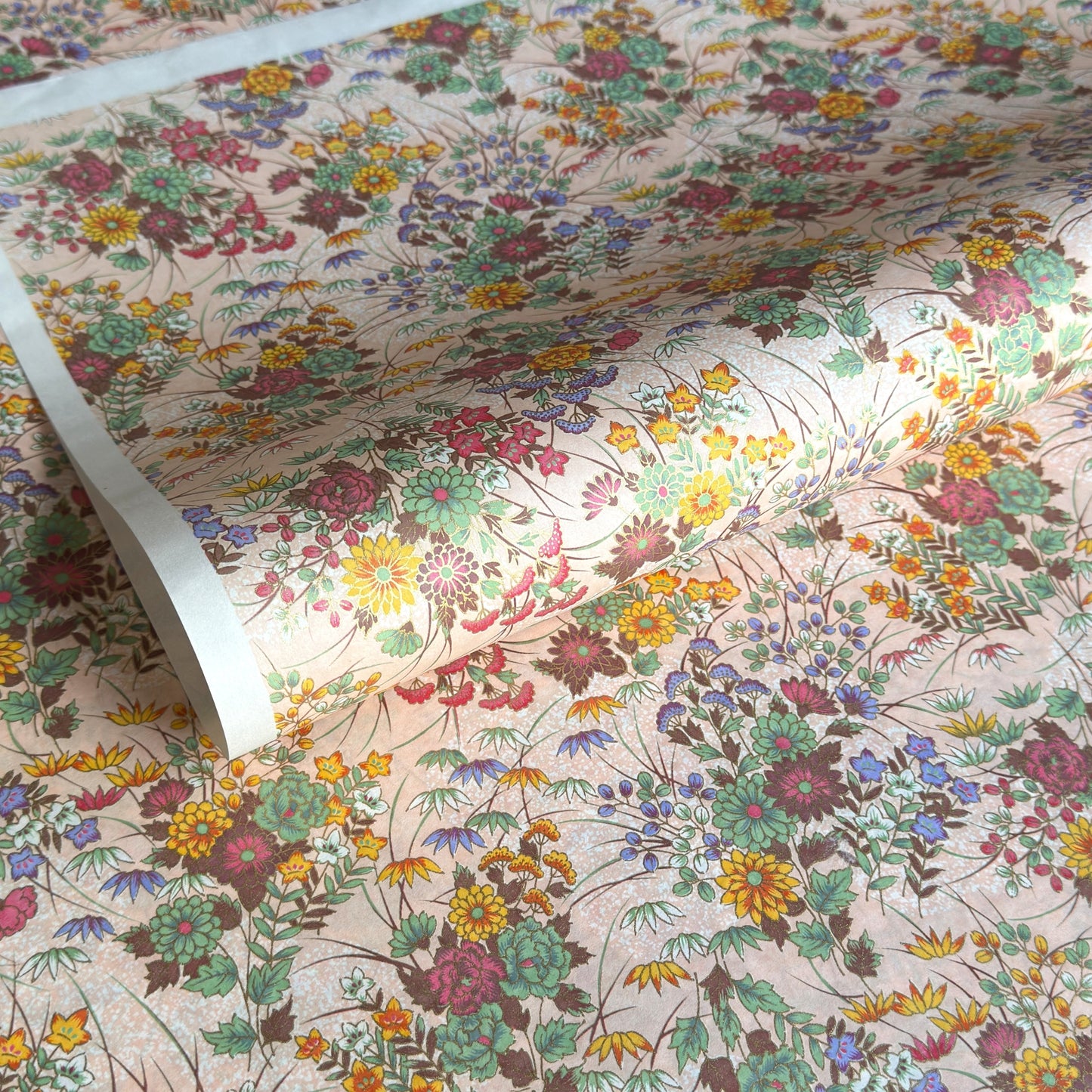 japanese silkscreen printed paper with a delicate floral bouquet design on blush pink background.