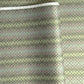 Japanese silkscreen chiyogami paper with a repeat pattern of stripes of a small floral motif in black, lilac and blue on a moss green backdrop