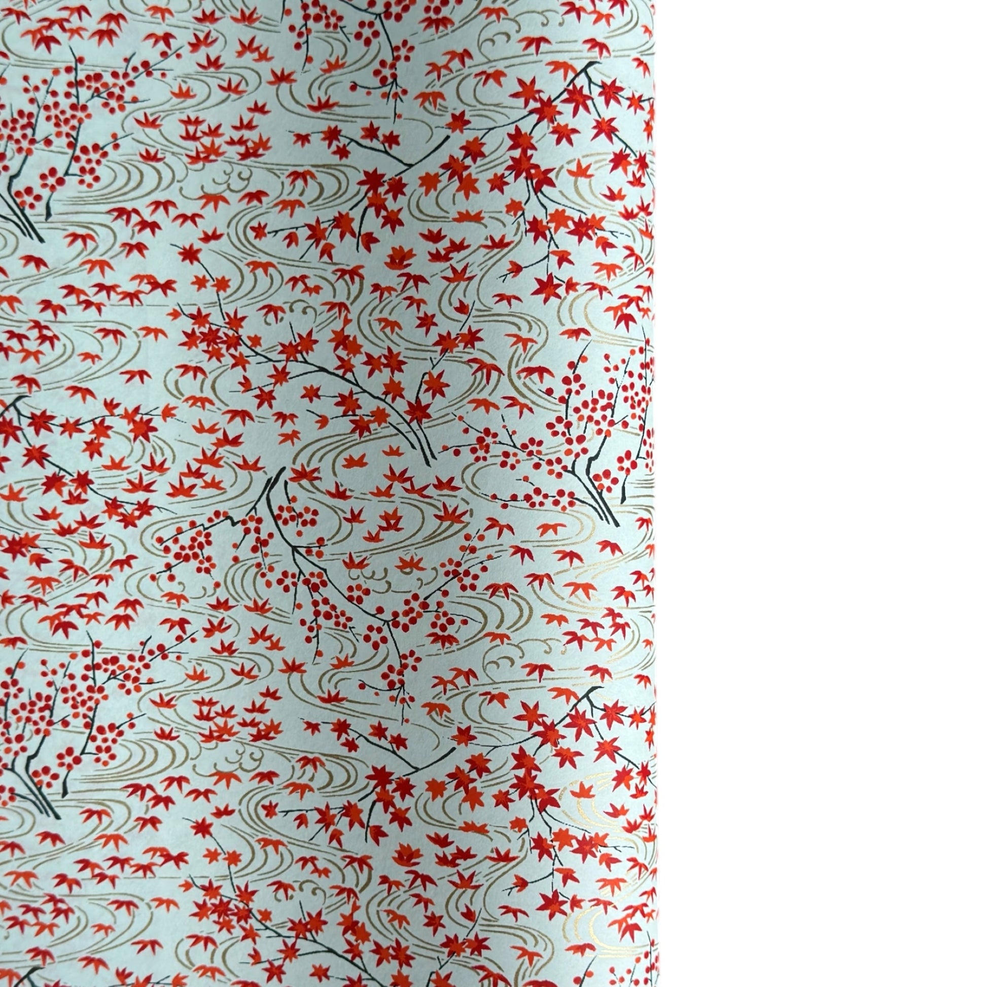 a sheet of japanese silkscreen printed chiyogami paper with a pattern of gold rivers, red falling leaves on a soft aqua background