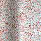 a sheet of japanese silkscreen printed chiyogami paper with a pattern of gold rivers, red falling leaves on a soft aqua background