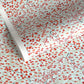 a sheet of japanese silkscreen printed chiyogami paper with a pattern of gold rivers, red falling leaves on a soft aqua background