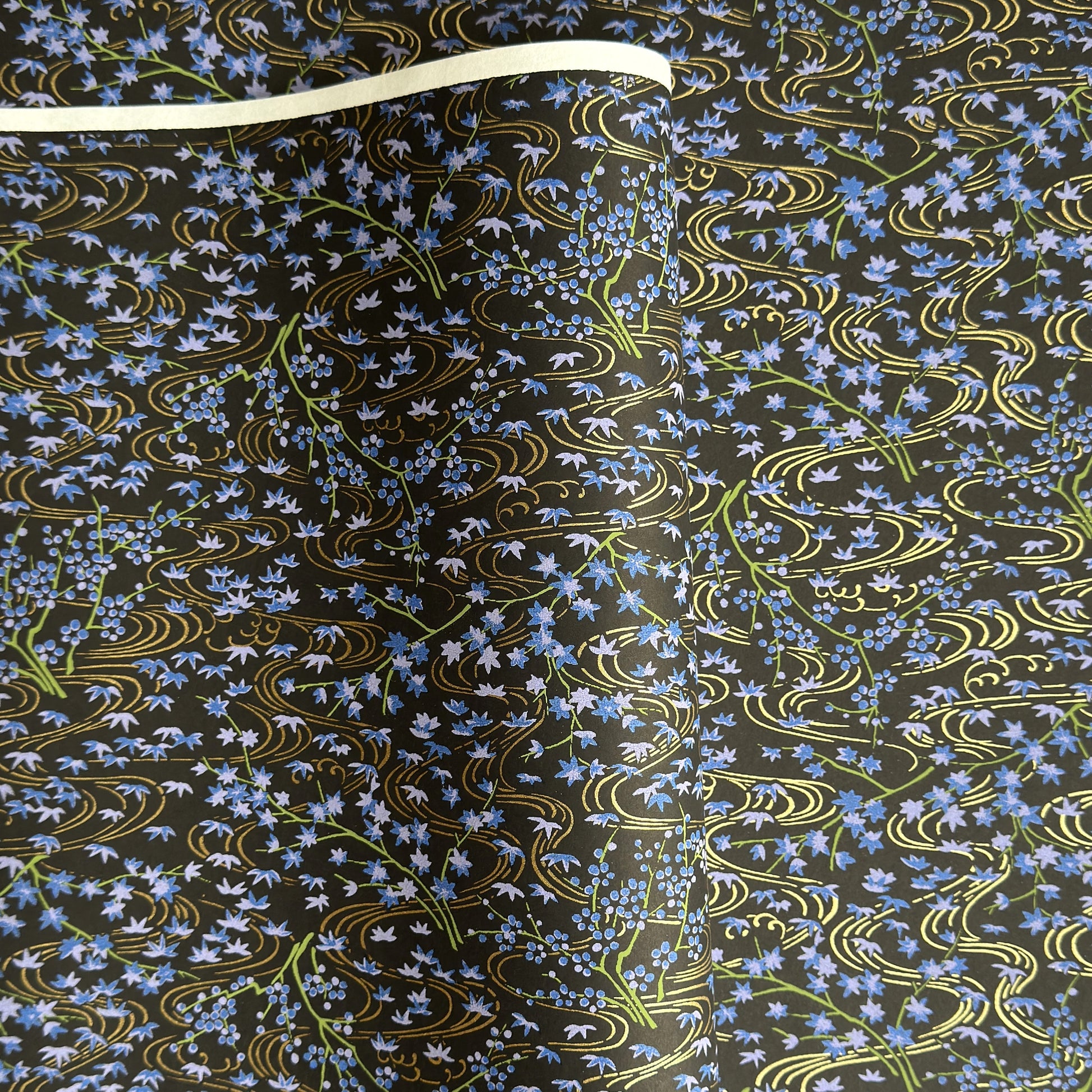 Gold rivers (kawa) with purple falling leaves (fukiyose) and foliage on a black backdrop. Japanese chiyogami paper